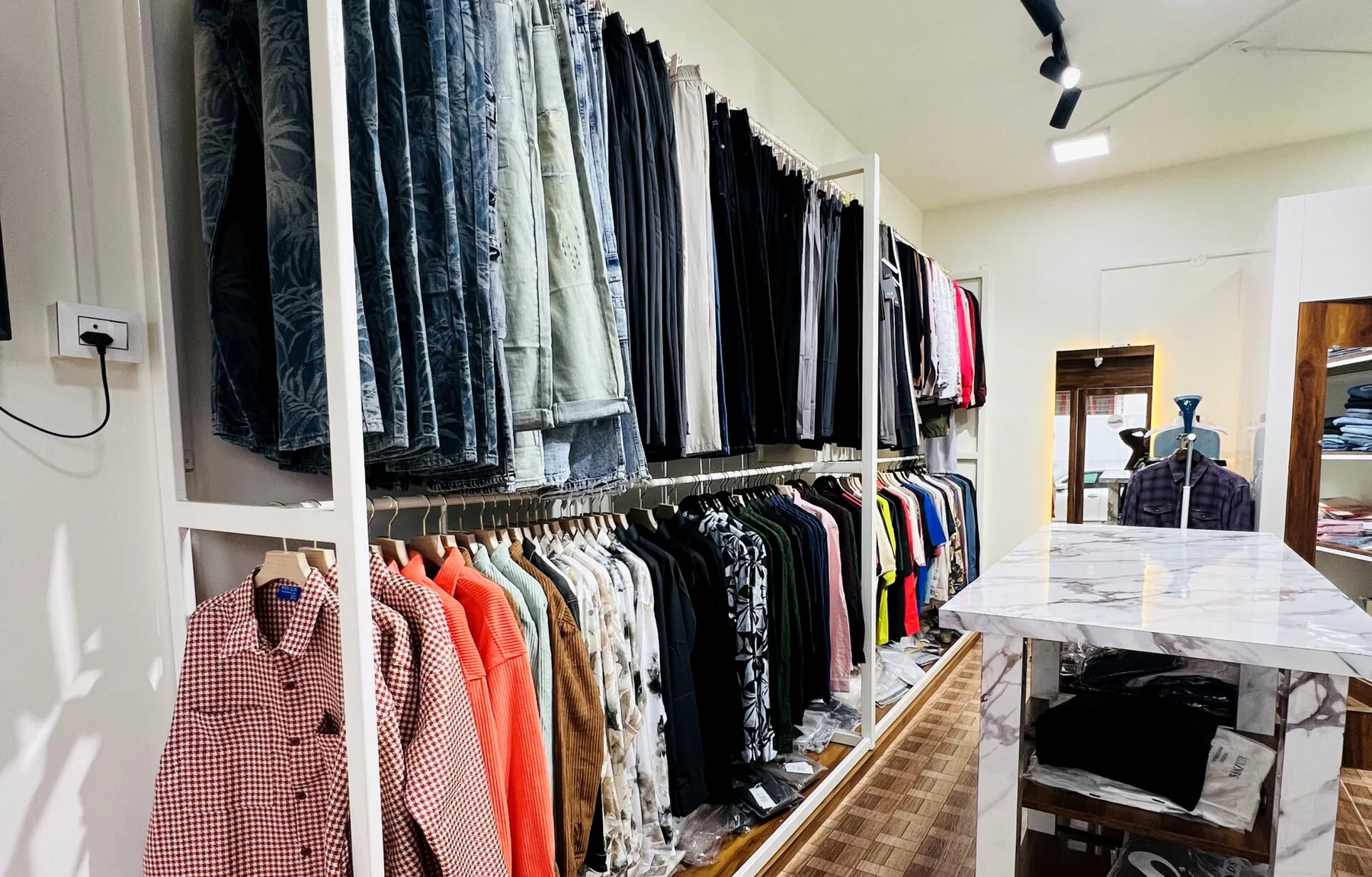 Inside the D Iconique men's wear showroom in Tirupati — racks of branded shirts, jeans and more